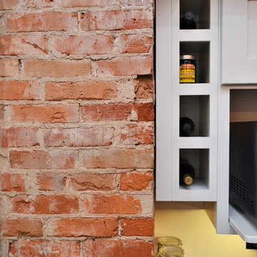 Bourbon, IN. Haas Signature Collection. Farmhouse Kitchen with Exposed Brick