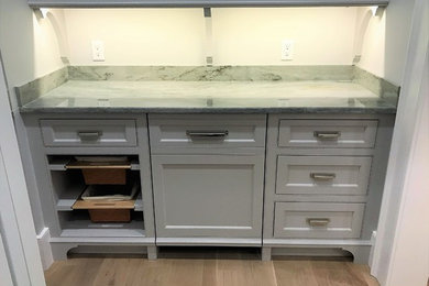 Kitchen pantry - small traditional single-wall medium tone wood floor kitchen pantry idea in Boston with beaded inset cabinets, gray cabinets and granite countertops