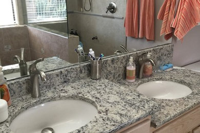 Inspiration for a mid-sized timeless 3/4 beige tile ceramic tile alcove shower remodel in Phoenix with shaker cabinets, light wood cabinets, a two-piece toilet, beige walls, a drop-in sink and tile countertops