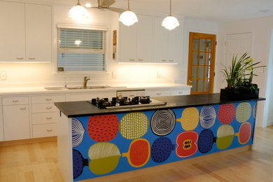 Inspiration for a mid-sized contemporary l-shaped light wood floor eat-in kitchen remodel in Toronto with a double-bowl sink, flat-panel cabinets, white cabinets, soapstone countertops, white backsplash, white appliances and an island