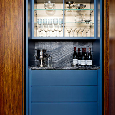 Example of a mid-sized trendy single-wall medium tone wood floor and brown floor dry bar design in Toronto with flat-panel cabinets, blue cabinets, granite countertops, multicolored backsplash, granite backsplash and multicolored countertops