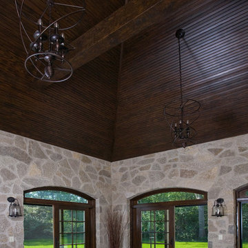 Stone Sun Room featuring Arch Top Sliding French Doors and Bead Board Ceiling
