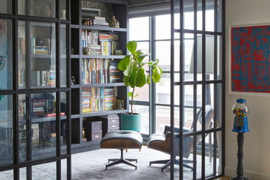 Mid-sized trendy built-in desk wallpaper home office library photo in New York with multicolored walls