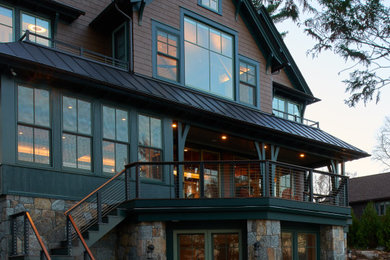 Large coastal brown three-story wood exterior home idea in New York with a shingle roof