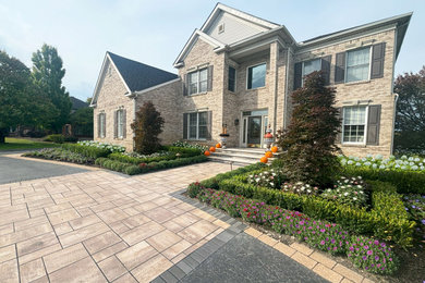 Photo of a french country full sun front yard brick landscaping in Detroit for summer.