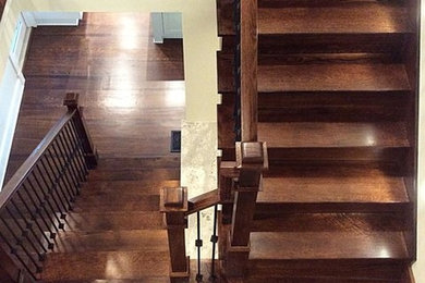 Design ideas for a large contemporary wood l-shaped staircase in Atlanta with wood risers and mixed railing.