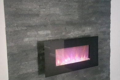 Basement - large transitional underground carpeted and beige floor basement idea in Philadelphia with gray walls and a stone fireplace