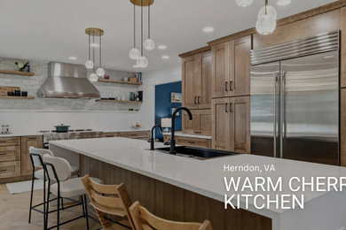 Inspiration for a large transitional l-shaped light wood floor and brown floor open concept kitchen remodel in DC Metro with a farmhouse sink, shaker cabinets, medium tone wood cabinets, quartz countertops, white backsplash, quartz backsplash, stainless steel appliances, an island and white countertops