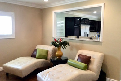 Inspiration for a mid-sized transitional open concept medium tone wood floor family room remodel in Los Angeles with beige walls