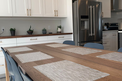 Inspiration for a mid-sized contemporary vinyl floor and gray floor kitchen/dining room combo remodel in Other with white walls