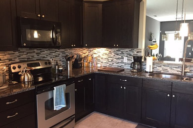 Inspiration for a mid-sized transitional u-shaped porcelain tile enclosed kitchen remodel in Other with a double-bowl sink, shaker cabinets, dark wood cabinets, granite countertops, gray backsplash, mosaic tile backsplash, stainless steel appliances and an island