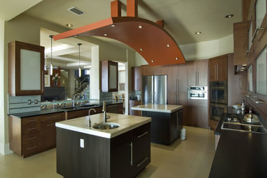 Example of a large trendy u-shaped linoleum floor open concept kitchen design in Other with an undermount sink, flat-panel cabinets, dark wood cabinets, marble countertops, multicolored backsplash, stainless steel appliances and two islands