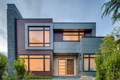 Example of a minimalist metal exterior home design in Vancouver
