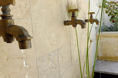 Travertine waterwall with Brass taps