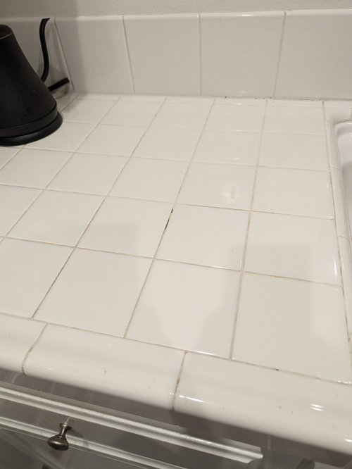 Chipped and worndown grout on kitchen counter.