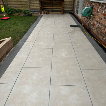 Cream Porcelain Patio Edged in Charcoal to a Bench