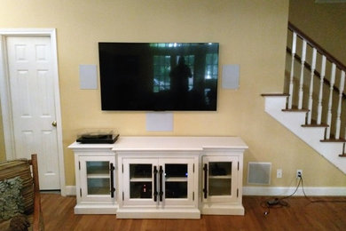 Family room - mid-sized modern enclosed family room idea in Houston with a wall-mounted tv