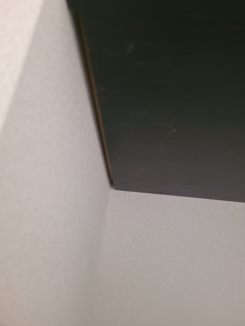 Gaps between built in shelves and wall