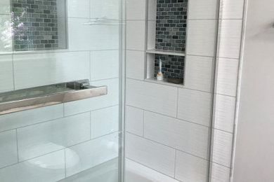 Mid-sized minimalist master laminate floor and gray floor bathroom photo in DC Metro with furniture-like cabinets, white cabinets, a two-piece toilet, gray walls, an undermount sink, quartz countertops and gray countertops