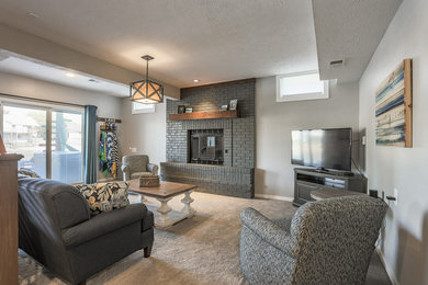 Mid-sized beach style family room photo in Omaha with a brick fireplace