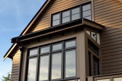 Design ideas for a large traditional two-storey brown exterior in Seattle with wood siding.