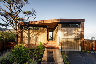 Example of a mid-sized minimalist one-story wood house exterior design in Portland