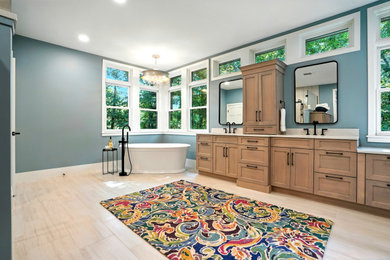 Inspiration for a large transitional master blue tile porcelain tile and double-sink bathroom remodel in Cedar Rapids with recessed-panel cabinets, light wood cabinets, a two-piece toilet, blue walls, an undermount sink, quartzite countertops, a hinged shower door, white countertops and a built-in vanity