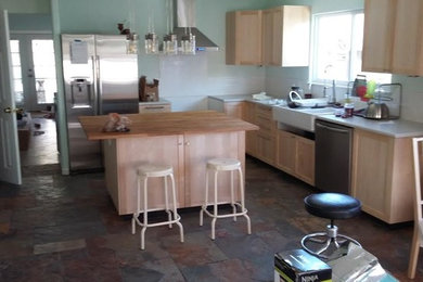 Small trendy l-shaped ceramic tile eat-in kitchen photo in Houston with light wood cabinets, wood countertops, white backsplash, subway tile backsplash, stainless steel appliances, an island and a farmhouse sink
