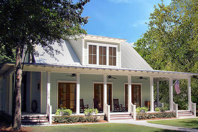 Mid-sized beach style green two-story wood exterior home photo in Other with a metal roof