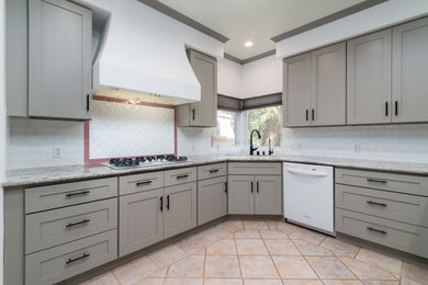 Mid-sized ornate u-shaped eat-in kitchen photo in Los Angeles with an undermount sink, shaker cabinets, gray cabinets, granite countertops, white backsplash, subway tile backsplash, white appliances and multicolored countertops