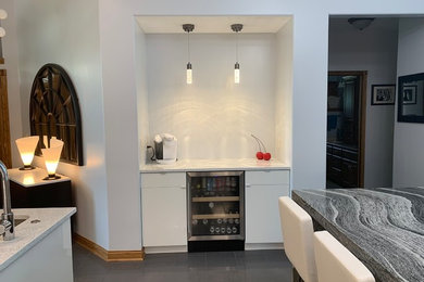 Trendy home bar photo in Omaha with flat-panel cabinets, white cabinets and granite countertops