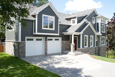 Elegant three-story concrete fiberboard exterior home photo in Other