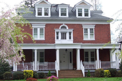 Inspiration for a large timeless red three-story brick exterior home remodel in Philadelphia with a hip roof
