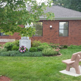 This is an example of a small traditional full sun front yard mulch landscaping in Chicago for summer.