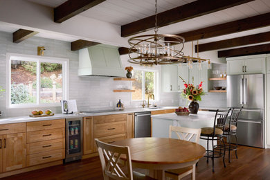 Eat-in kitchen - mid-sized transitional l-shaped medium tone wood floor, brown floor and exposed beam eat-in kitchen idea in Other with a single-bowl sink, shaker cabinets, medium tone wood cabinets, quartz countertops, white backsplash, subway tile backsplash, stainless steel appliances, an island and white countertops