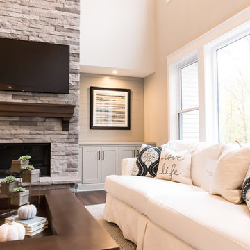 Living Room Remodel Featuring a Ledgestone Fireplace + Cabinetry + Shaw Coretec