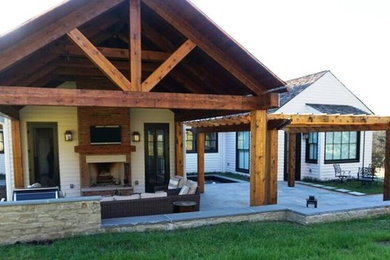 Example of an arts and crafts backyard stone patio fountain design in Nashville with a roof extension