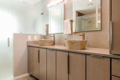 Mid-sized urban master gray tile double-sink alcove shower photo in Baltimore with flat-panel cabinets, gray cabinets, quartz countertops, a hinged shower door, brown countertops and a built-in vanity