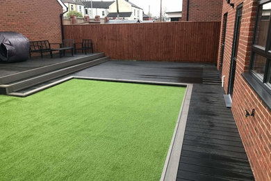 Midnight premium composite decking with flint boarder complete with artificial l