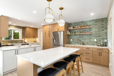 Inspiration for a mid-sized contemporary u-shaped eat-in kitchen remodel in Seattle with an undermount sink, shaker cabinets, quartz countertops, porcelain backsplash, stainless steel appliances and two islands