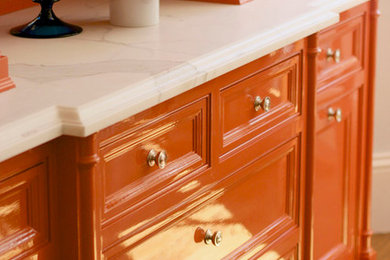 Inspiration for a transitional eat-in kitchen remodel in San Francisco with orange cabinets and marble countertops