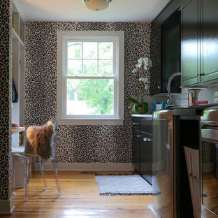Inspiration for a mid-sized eclectic galley light wood floor and brown floor dedicated laundry room remodel in Richmond with an undermount sink, shaker cabinets, dark wood cabinets and a side-by-side washer/dryer