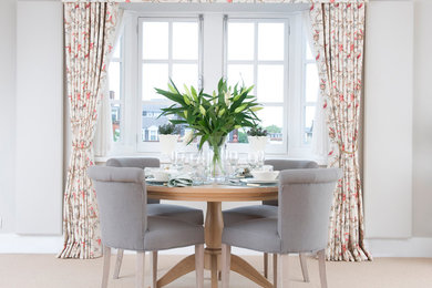 Example of a classic carpeted dining room design in London with gray walls