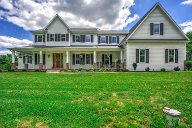 Large elegant white two-story vinyl exterior home photo in Philadelphia with a shingle roof