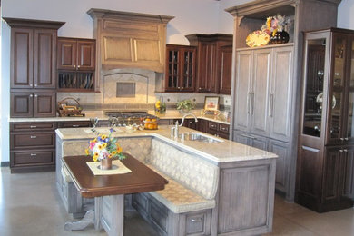 Example of a classic l-shaped concrete floor and gray floor open concept kitchen design in Denver with a double-bowl sink, raised-panel cabinets, dark wood cabinets, quartzite countertops, beige backsplash, ceramic backsplash, paneled appliances and an island