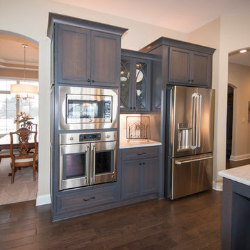 Wall ovens, a small serving area or coffee station, and refrigerator