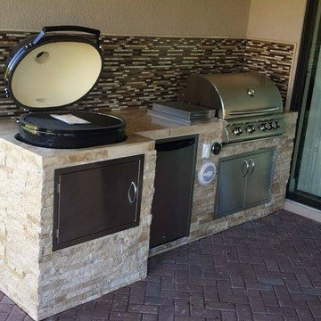 Outdoor Kitchen with Stacked Stone Exterior and Primo Oval