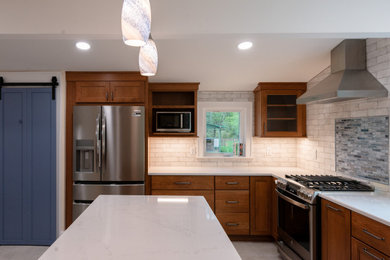 Large minimalist white floor kitchen photo in Other with recessed-panel cabinets, dark wood cabinets, quartzite countertops, blue backsplash, stainless steel appliances, an island and white countertops