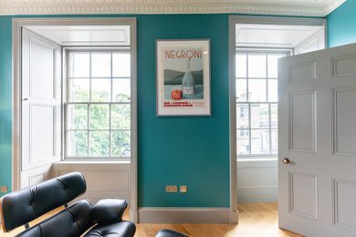 This is an example of a contemporary living room in Edinburgh with blue walls.