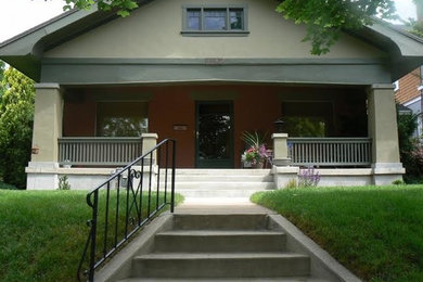 Inspiration for a mid-sized craftsman concrete front porch remodel in Salt Lake City with a roof extension